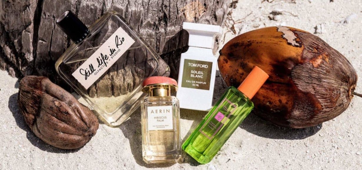 Beach-inspired fragrance collection with aquatic bottles and tropical elements