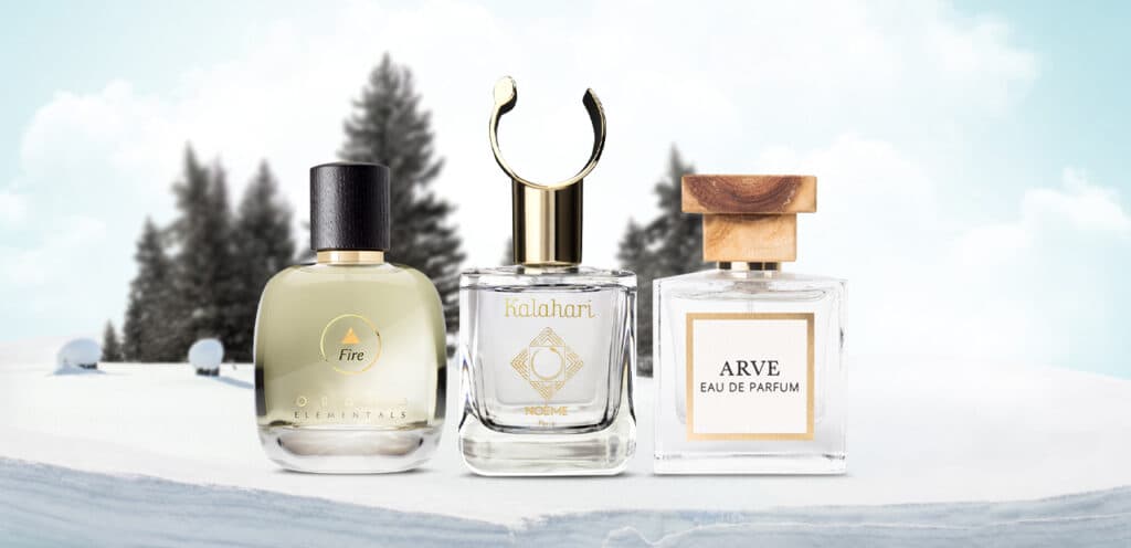 Luxurious winter fragrance bottles with warm lighting and cozy elements like cashmere and candles